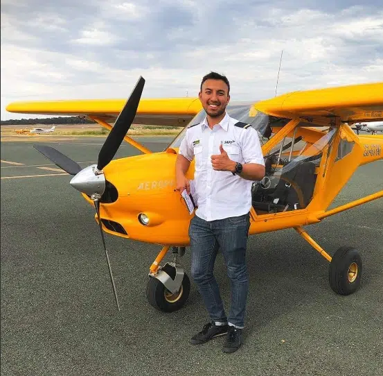 Photo of Tenfold business coach Diraj Ranjit besaide a light aircraft he pilots